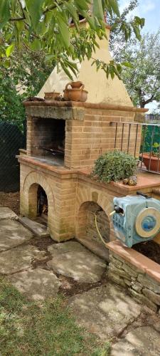 een steenoven op een bankje in een tuin bij Luminoso e accogliente in Cortona