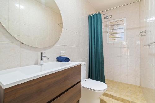 a bathroom with a sink and a toilet and a mirror at Maravia Bonaire in Kralendijk