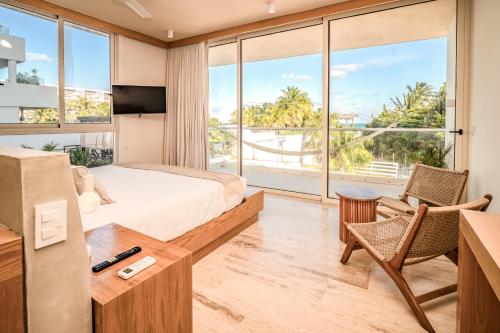 En eller flere senge i et værelse på Greta Puerto Morelos