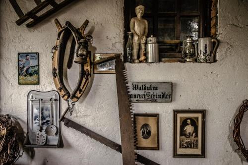 a wall with a cross and pictures on it at Hotel Faxe Schwarzwälder Hof in Kappelrodeck