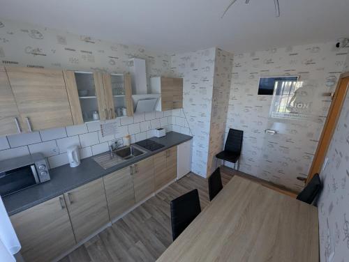 una cucina con mobili in legno e un tavolo in legno di Pension zum Ringelberg a Erfurt