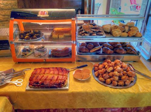 a table topped with lots of different types of food at Hotel Residence Villa Rioddi in Volterra