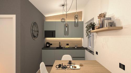 een keuken met een houten tafel en een wastafel bij Casa Reiner in Bondone