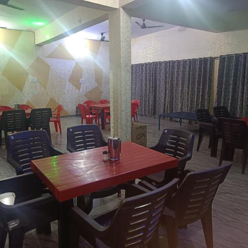 a dining room with a wooden table and chairs at Shiv Shakti Hotel And Resort in Mākundgarh