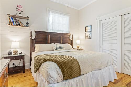 a bedroom with a large bed with a wooden headboard at The Island Suite at KW Vacation in Key West