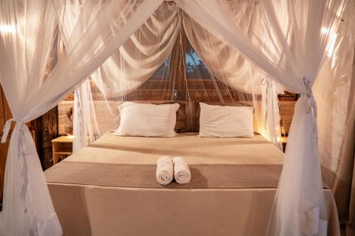 Cama ou camas em um quarto em Vila do Junco