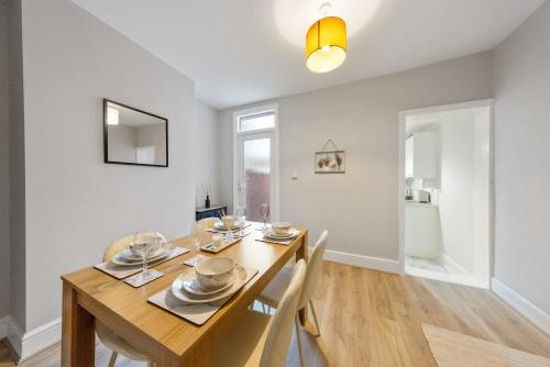 a dining room with a wooden table and chairs at 12 osbourne road in Gillingham