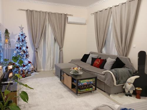 a living room with a christmas tree and a couch at Ηome & Garden with parking close to Olympic Stadium in Athens