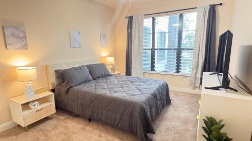 a bedroom with a bed and a large window at Relaxing Pool-View 1BR Near Top Houston Spots in Houston