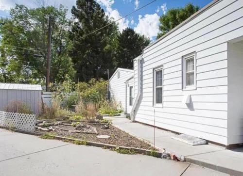 a house with a garden next to a building at 1 Min to Hospitals Spacious 4 Bed Stay in Billings