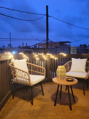 two chairs and a table on a balcony with lights at Downtown 1BD APT, Walk to Stadiums, Free Parking in Baltimore