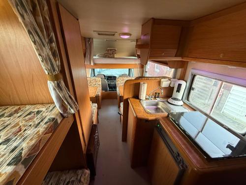 an interior view of a kitchen in a rv at Camper room bunde in Bunde