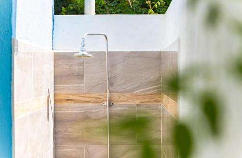 a shower with a glass door in a bathroom at Something Els in Willemstad