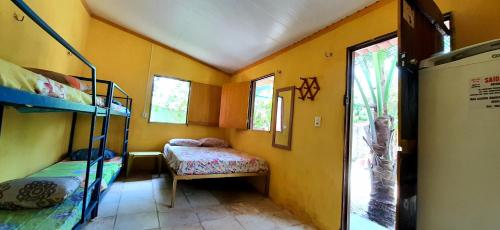 a room with two bunk beds and a window at casa n 3 jeri in Jericoacoara