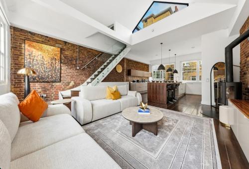 a living room with a brick wall at The Marylebone Villa in London