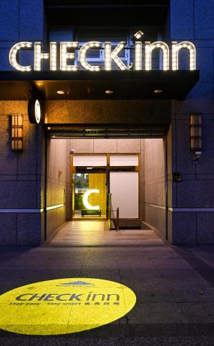 an entrance to a building with a sign on it at CHECK inn Taipei Songjiang in Taipei