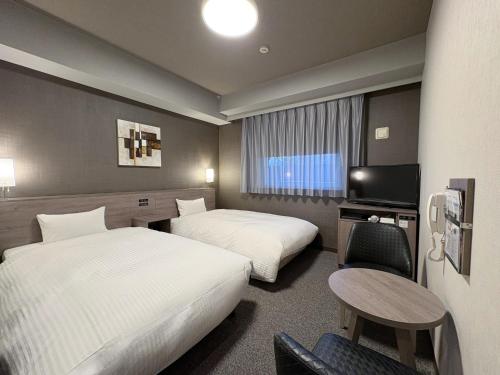 Postel nebo postele na pokoji v ubytování Hotel Route-Inn Dai-ni Nishinasuno