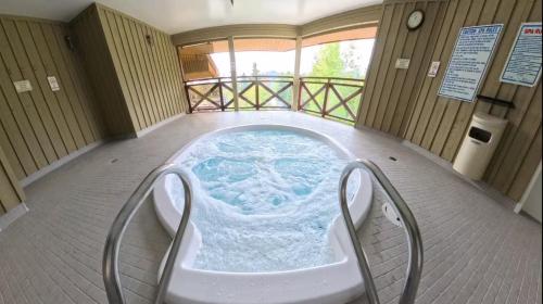 a jacuzzi tub in the middle of a room at Whistler Village 2BR 2BA Top-Floor Condo with Hot Tub and Parking in Whistler