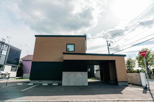 a building with a garage with a window at 藤乃宿 ペットと暮らすように泊まる宿 in Sapporo