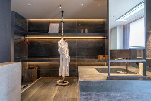 a bathroom with a towel hanging on a chain at The Moor in Busan