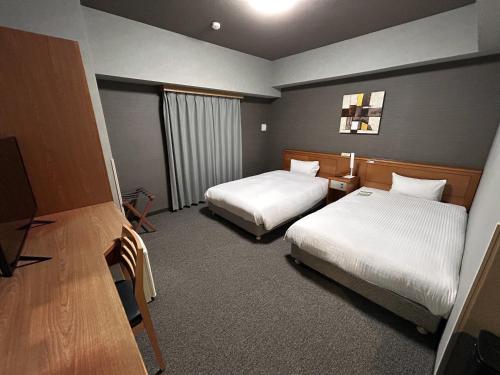 En eller flere senge i et værelse på Hotel Route-Inn Hamanako
