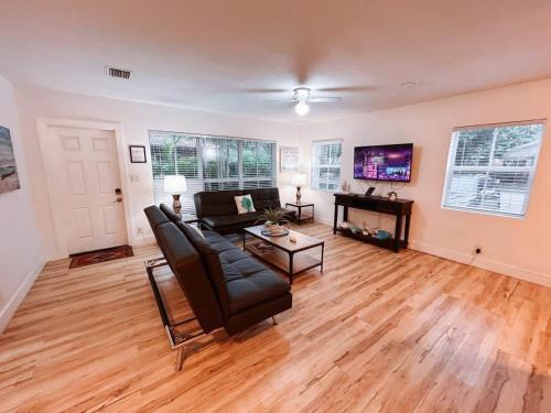 a living room with a couch and a table at Beach Getaway One Block from the Beach in Pompano Beach