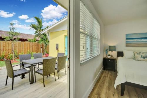 a bedroom with a bed and a table and chairs at Beach Escape One Block from the Beach in Pompano Beach