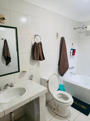 een witte badkamer met een toilet en een wastafel bij Terraza 419 in Tarija