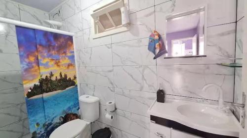 a bathroom with a toilet and a sink at Casa com jacuzzi in Florianópolis