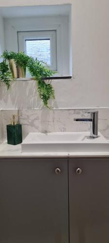 a bathroom sink with a mirror and a window at Contractors & Families Large Drive M1 M69 Wifi in Leicester