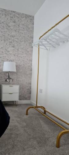 a white room with a bed and a table with a lamp at Contractors & Families Large Drive M1 M69 Wifi in Leicester