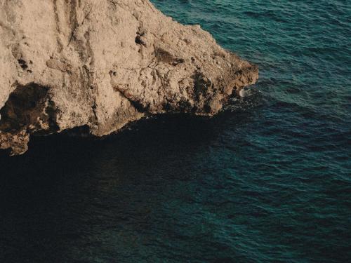 an aerial view of the ocean next to a cliff at Hyde Perth in Perth