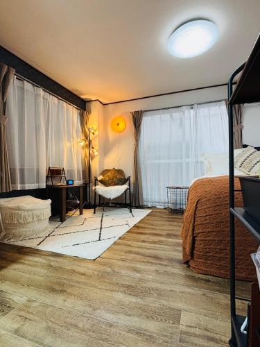 a bedroom with a bed and a desk and a window at Shimokitazawa Cozy Apartment 202 in Tokyo