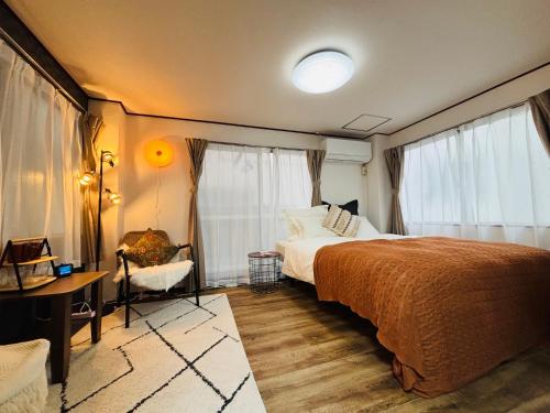 a bedroom with a bed and a desk and window at Shimokitazawa Cozy Apartment 202 in Tokyo