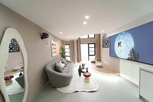 a living room with a couch and a tv at Qixin Homestay in Changsha