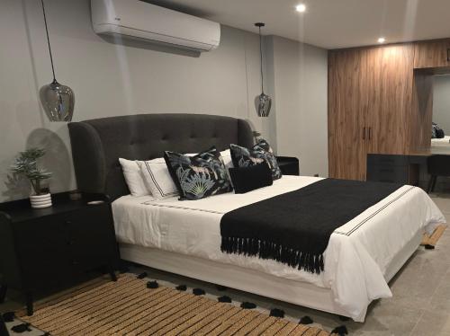 a bedroom with a large bed with pillows on it at Crane's Nest - Luxury Ground in Pretoria
