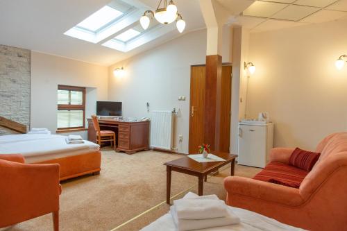 a hotel room with a bed and a desk at Hotel Grand in Žilina