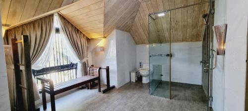 a bathroom with a toilet and a glass shower at LumiShora Villa - Bai Truong, Phu Quoc in Phú Quốc