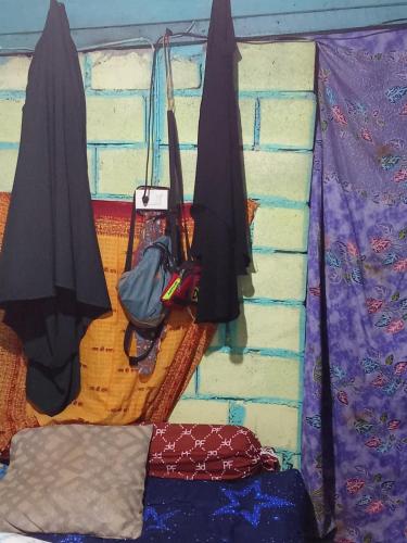 two umbrellas are hanging on a brick wall at Easy Life Hut in Ko Bu Bu