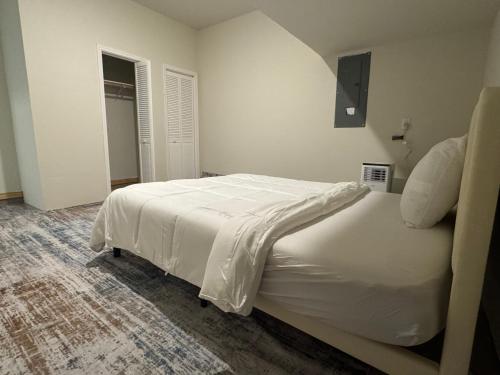 a bedroom with a white bed in a room at Luxury 12 Bedroom Villa in Denton