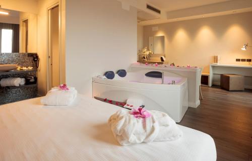 a spa room with a bath tub and a sink at Hotel Garden Experience in Città di Castello