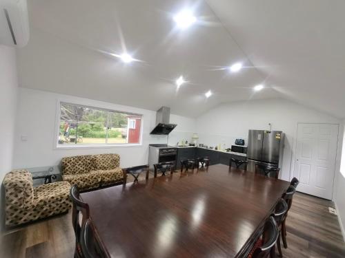 a living room with a table and a kitchen at Christian's Minde Jervis bay in Jervis Bay Village