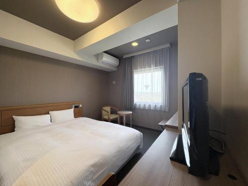 Postel nebo postele na pokoji v ubytování Hotel Route-Inn Nishinasuno