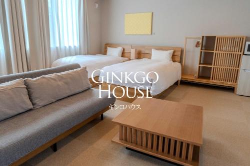 a living room with two beds and a couch at Ginkgo House ギンコハウス in Fujiyoshida