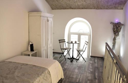 a bedroom with a bed and a table with chairs at Trieste Art Loft in Trieste