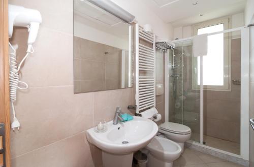 a bathroom with a sink and a toilet and a shower at Residence T2 in Rimini