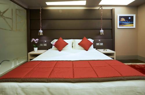 a bedroom with a large bed with red pillows at Harry's Bar Trevi Hotel & Restaurant in Rome