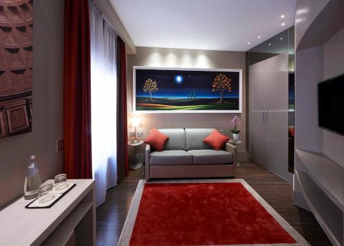 a living room with a couch and a red rug at Harry's Bar Trevi Hotel & Restaurant in Rome