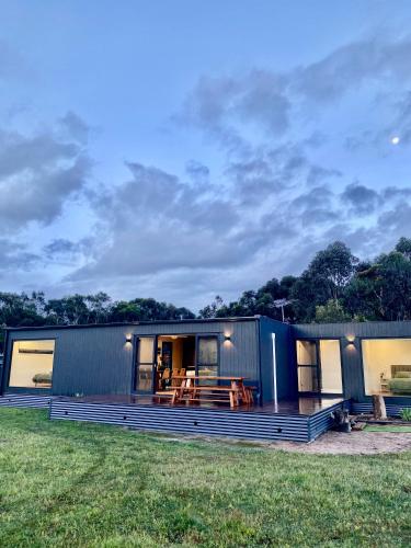 a modular home with a deck and a house at Grampians View Eco Retreat in Halls Gap