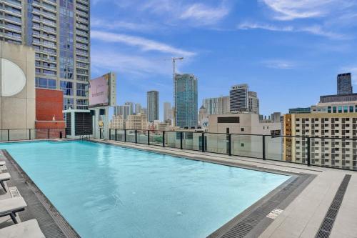 a large swimming pool on the roof of a building at Luxury Miami Studio 27th Floor in Miami